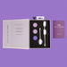 An open box displays the Wellness Kegel Ball Training Kit for Pelvic Floor Health with three pairs of purple and white kegel balls, an instruction booklet on the left, and a purple wellness guide on the right, all against a purple background.