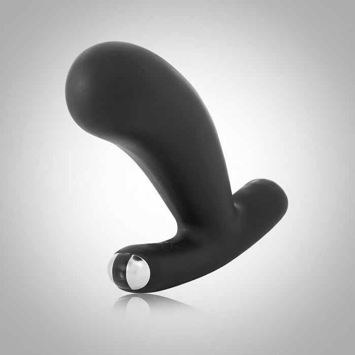 The Je Joue Nuo V.2 is a sleek black silicone dual-motor anal plug with a curved, ergonomic design and shiny silver base accent, shown on a light gray gradient background. App-compatible and ideal for exploring prostate play.