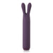 The Je Joue Powerful Bullet with Flexible Rabbit Ears - Purple by Je Joue is a sleek, cylindrical silicone rabbit vibrator featuring two flexible, rabbit ear-like appendages at the top. This rechargeable toy offers rumbly vibrations and has three buttons on its front side marked with plus, minus, and power symbols.