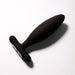 The Je Joue Vesta Petite Powerful Remote Control Vibrating Butt Plug, made from body-safe silicone with a smooth tapered design and flared base, is shown resting on a white surface.