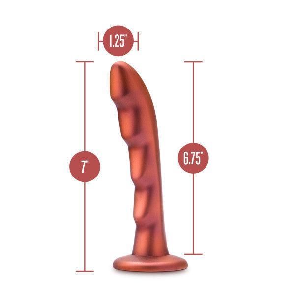 The Jealousy 7 Inch Rippled Silicone Dildo by Blush is a bronze-colored toy designed for g-spot stimulation, featuring ridges and a suction cup base. It measures 7 inches in total length with an insertable length of 6.75 inches and a diameter of 1.25 inches, making it perfect for adventurous strap-on play.