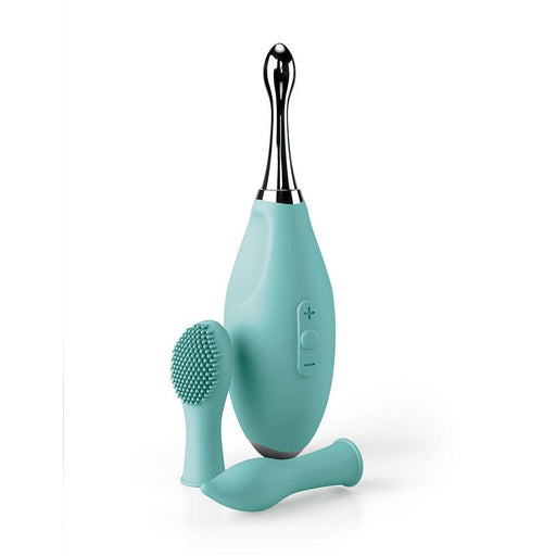 A teal Jimmyjane Focus Pro Pinpoint Tip Clitoral Vibrator by Pipedream Products featuring Sonic vibrations with two silicone head attachments on a white background. The device showcases a sleek design with a metallic top and control buttons on the front. The attachments include a rounded massager and a brush head.