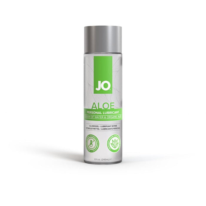 A bottle of System Jo's JO Aloe Water Based Sensitive Skin Lubricant, infused with water and organic aloe, is shown against a white background. The clear bottle with a green and silver label and cap holds 8 fluid ounces (240 milliliters). The label highlights its key features with icons and mentions its pH balanced formula.