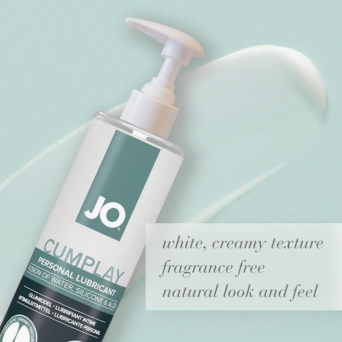 On a light green background, an 8 oz bottle of System Jo's JO Cumplay Hybrid Personal Lubricant with Aloe takes center stage, ready to fulfill your cumplay fantasies. The text around it highlights its "aloe infused, creamy texture, fragrance-free" qualities that offer a natural look and feel. The backdrop showcases a smooth, white swirl design.