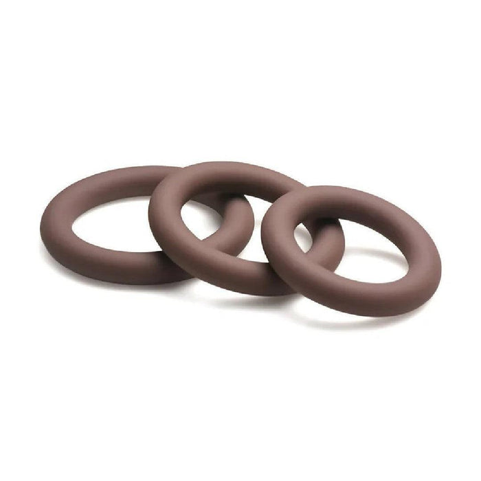 Three interconnected silicone cock rings, crafted from stretchy silicone, are positioned in a triangular arrangement on a plain white background. The Jock Discreet Stretchy Silicone Cock Ring Set of 3 - Chocolate by Curve Toys appear smooth and evenly shaped, offering graduated sizes for varied uses.