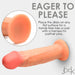 Close-up image of the Jock Real Skin 8.5 Inch Silicone Suction Cup Dildo by XR Brands, featuring a dual-density design. Text reads: "Eager to Please. Place this vanilla-toned dildo on any flat surface for a hands-free ride or pair with a harness for partner play." Dildo is light skin-toned with pinkish tip.