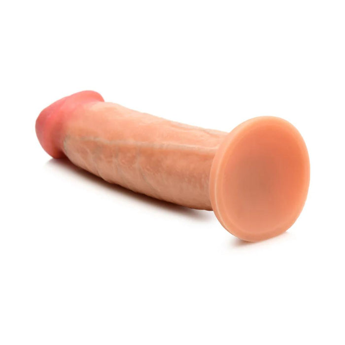 Displayed against a white background is the Jock Real Skin 8.5 Inch Silicone Suction Cup Dildo in a vanilla hue, featuring a cylindrical shape with a rounded end and wider base. This XR Brands product offers dual density for a lifelike touch and feel, perfect for those seeking an authentic experience.