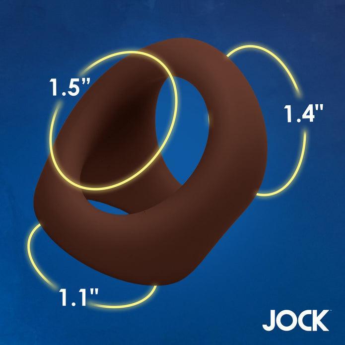 A torus-shaped JOCK Silicone Cock & Ball Ring in dark skin tone, featuring three yellow rings and sizes 1.5", 1.4", and 1.1", displayed on a blue background with "JOCK" in the bottom right corner.
