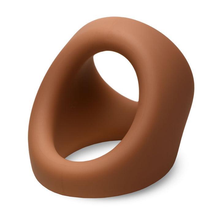 The JOCK Silicone Cock & Ball Ring in medium skin tone features a modern, abstract design with a smooth surface, oval openings, and an angled, asymmetrical shape.