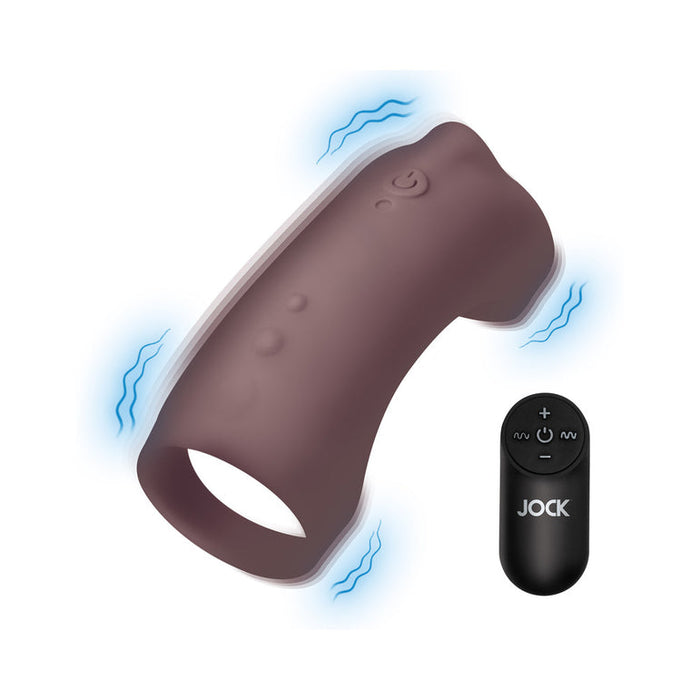 The Jock Vibrating Penis Sleeve and Support with Remote - Chocolate is a body-safe silicone, remote-controlled ring in black with a curved, textured design and easy-use button details. Blue lines highlight its strong vibrations.