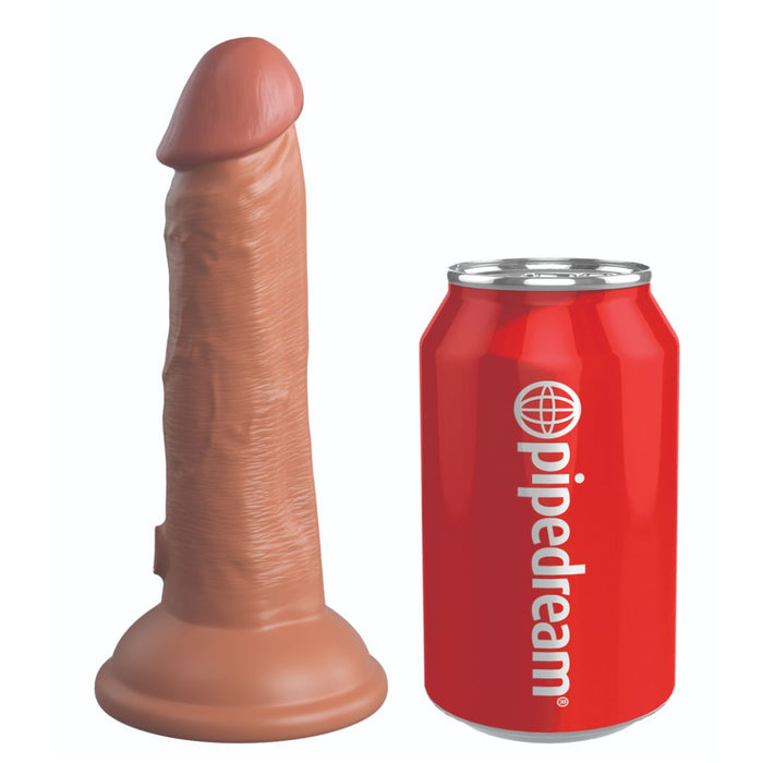 A realistic King Cock Elite 6" Vibrating Silicone Dual Density Dildo - Caramel standing upright next to a red can labeled 'Pipedream Products' on a white background.