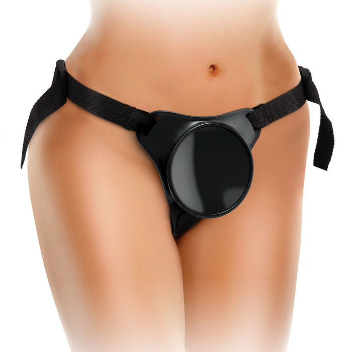 A person wearing a black King Cock Elite Beginner's 6 Inch Silicone Dildo + Body Dock Strap-on Harness by Pipedream Products around their waist and hips. The harness is fastened with adjustable black straps and features a circular base at the front to secure a suction cup dildo. The background is white and fades to highlight the product.