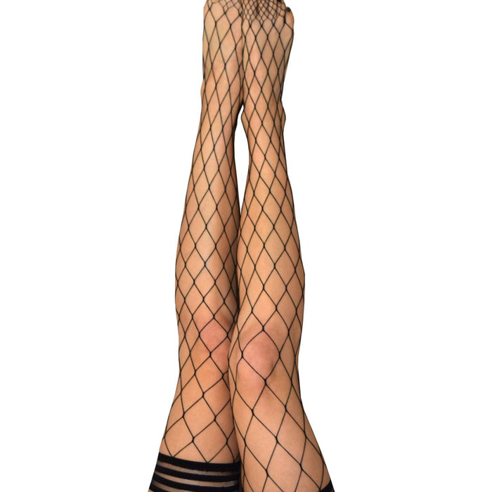 A pair of legs wearing Kix'ies Michelle Black Fishnet Thigh Highs (sizes A-D), featuring black large net fishnet patterns with wide elastic bands at the top and no-slip-grip technology. The backdrop is plain white, accentuating the mesh details. Toes are pointed outward.