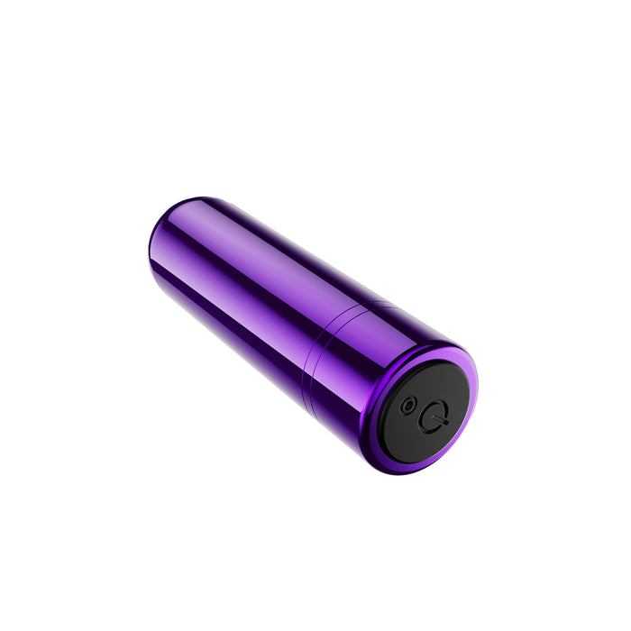 The Kool Vibes Rechargeable Mini Bullet from Blush is a sleek, cylindrical, purple metallic vibrator with a black button on one end. USB rechargeable and offering 5 speeds, the device is slightly tilted and isolated on a white background.