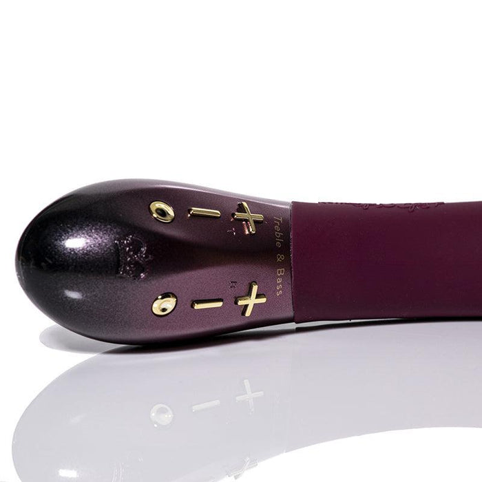 A close-up view reveals a stylish black and burgundy shoe tree with golden accents, thoughtfully designed for treble and bass control. The handle is adorned with engraved symbols and text, evoking the elegance of the customizable Kurve Dual Motor G-Spot Vibrator by Hot Octopuss. The shoe tree rests on a reflective white surface.