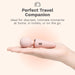A hand holds a small, pink wand-shaped personal massager. Text above reads: "Perfect Travel Companion. Ideal for discreet, intimate moments at home, in hotels, or on the go.