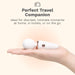 A hand holding a small white massage wand with rose gold accents. Text above reads: "Perfect Travel Companion. Ideal for discreet, intimate moments at home, in hotels, or on the go.