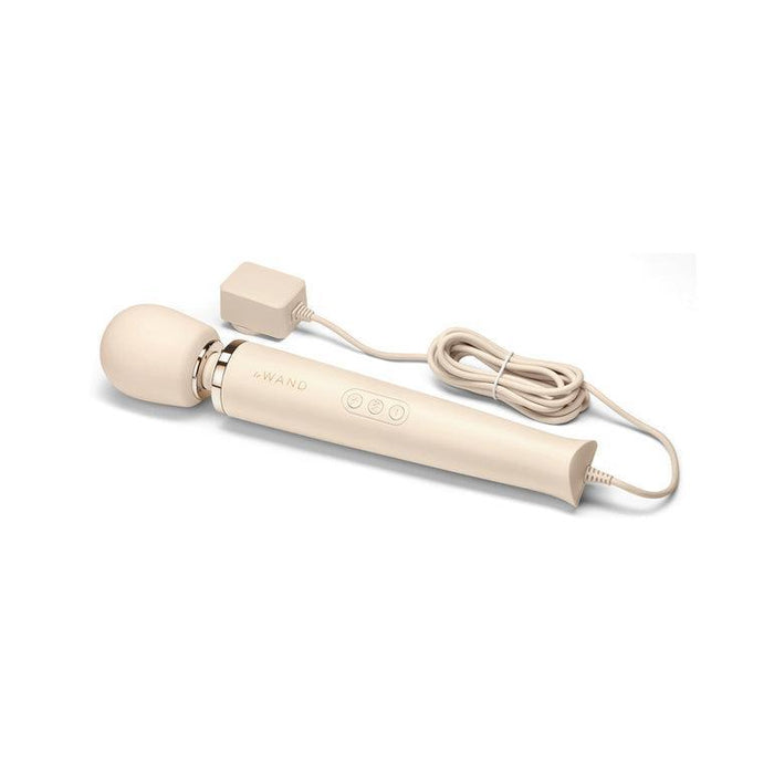 Image of the Le Wand Plug In Powerful Wand Vibrator - Cream by Le Wand. The vibrator features a rounded head, a lengthy handle with three control buttons and "#WAND" printed on it, and an attached power cord with a plug. The neatly coiled power cord is placed beside the massager, which is stored in a zippered case.