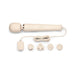 The Le Wand Plug In Powerful Wand Vibrator in cream, by Le Wand, is a beige handheld massager with a rounded head and an attached cord that leads to a power adapter. The set includes the vibrator, a coiled cord, a zippered storage case, and four interchangeable plug attachments. It boasts three control buttons on its body for ease of use.