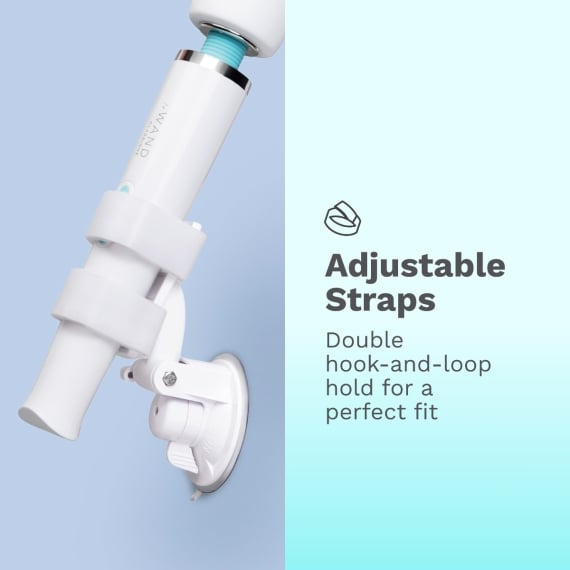 The Le Wand Adjustable Hands-Free Vibrator Mount with Suction Cup is shown on a light blue background. Text reads: "Adjustable Straps. Double hook-and-loop hold for a perfect fit.