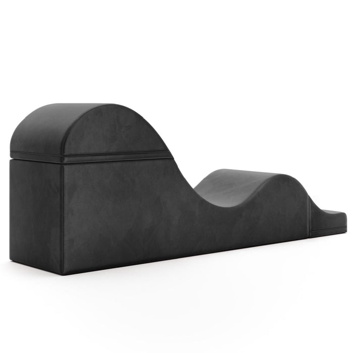 The Liberator Aria Flip Chaise Sex Lounger is a black, foam-covered ergonomic bench with a wave-like design, shown against a white background.