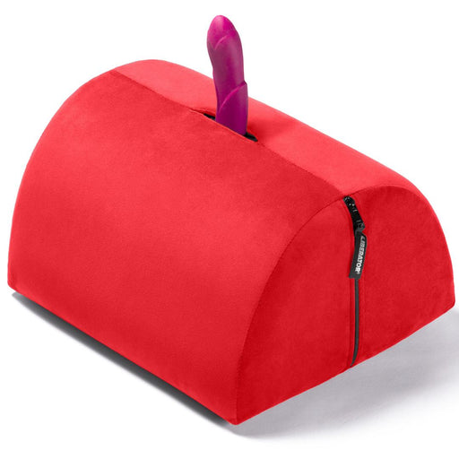 The Liberator BonBon Rideable Sex Toy Mount is a red, semi-cylindrical cushion with a zippered side and an opening on top for mounting a sex toy vertically.
