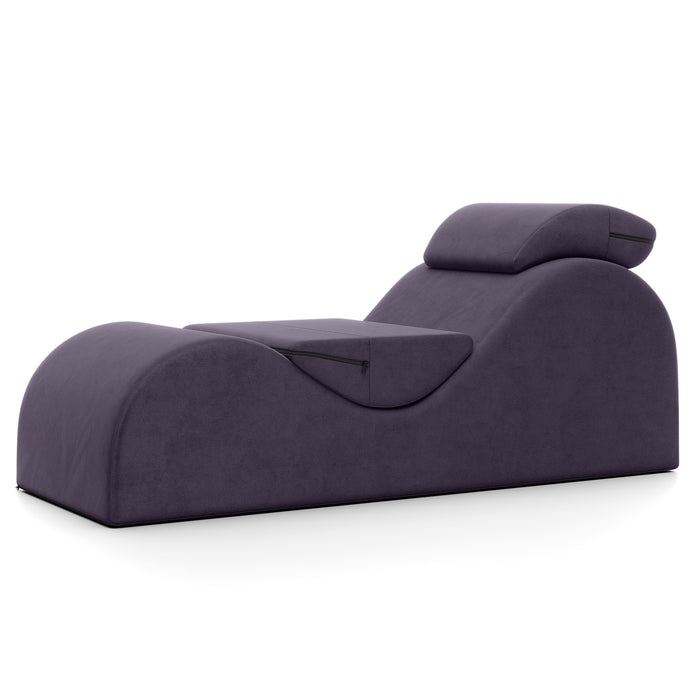 The Liberator Esse Sex Lounger features a curvy, ergonomic design, attached pillow, and comes in modern purple, shown against a white background.