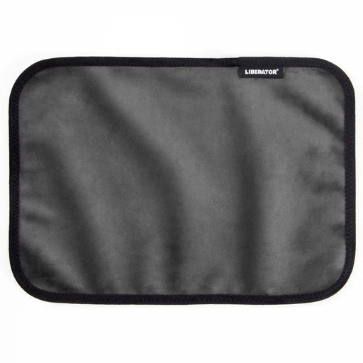 The Liberator Fascinator Toy Pad is a rectangular gray moisture-proof mini mat with rounded corners, black trim, and a small "Liberator" label in the upper right corner. The soft, smooth microfiber surface is likely machine-washable.