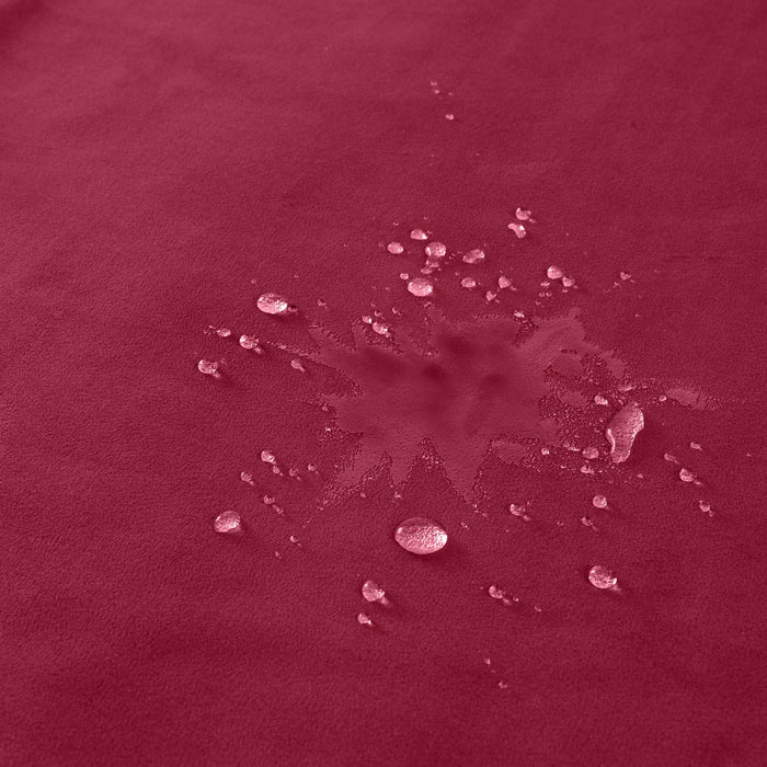 Water droplets scattered on the red Liberator Fascinator Travel Sized Waterproof Sex Blanket, highlighting its water-resistant and spill-absorbing qualities.