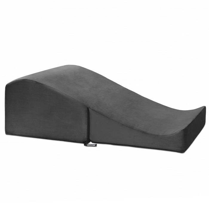 The Liberator Flip Ramp Convertible Sex Positioning Furniture is a black, wedge-shaped foam pillow with a gentle slope, offering ergonomic support and discreet use as an ottoman or sex ramp, shown on a plain white background.