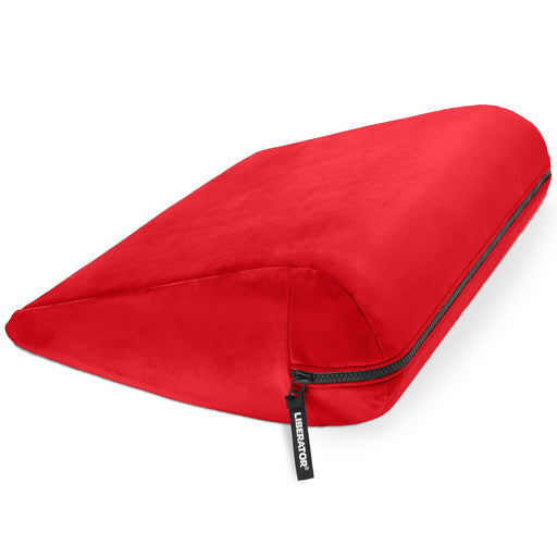 A bright red wedge-shaped Liberator Jaz – Discreet Positioning Support Cushion, featuring a visible zipper and a small black "Ubbeybox" tag, is displayed on a white background.
