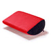 The Liberator Jaz Motion – Dual-Sided Rocking Positioning Cushion features a red top, black sides, and a zippered end, shown on a white background.