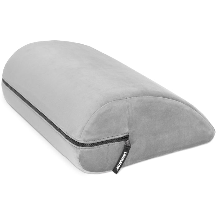 The Liberator Jaz Motion – Dual-Sided Rocking Positioning Cushion is a light gray, wedge-shaped pillow with memory foam and a zippered cover, shown on a white background—ideal for discreet support in the bedroom.