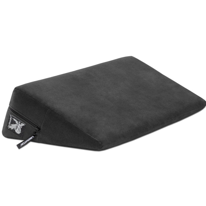 A black Liberator Wedge 24 Inches – The Original Sex Pillow for Deeper Angles, wedge-shaped with a zippered cover and small logo tag on the side, is shown on a white background.