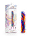 A vibrant marbled adult toy next to its packaging. The box prominently displays the product name "Limited Addiction Power Bullet Vibe - Psyche by Blush" and emphasizes features like waterproof functionality and multiple vibrating modes, including 10 deep rumbly vibrations. The design showcases vivid swirls in purple, blue, yellow, and red.