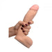 A hand with dark red nail polish holds the Loadz Squirting 8 Inch Vanilla Tone Dildo - Squeeze and Squirt by XR Brands, which features a flesh-colored, dual density design with a suction base. The dildo boasts a realistic design, including a defined head and textured shaft for an incredibly lifelike experience. The white background enhances its detail.