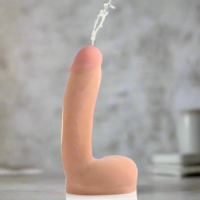 The Loadz Squirting 8 Inch Vanilla Tone Dildo - Squeeze and Squirt by XR Brands offers a realistic model of a flaccid penis with fluid pouring from the tip. Crafted to provide a lifelike feel, this light skin-toned dildo stands on a plain white background, perfectly capturing authenticity and detail.