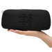 Happy Rabbit LOVE Medium Silicone Zipper Storage Case - Black held in a hand