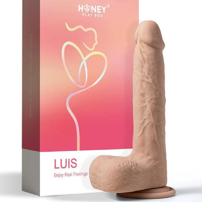 An image of a realistic Luis Thrusting Warming Large 8.5" App Controlled Dildo by Honey Play Box, next to its packaging, which features a pale pink background and a heart-shaped design.
