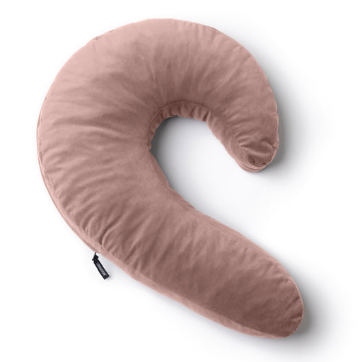 The Liberator Lune Snuggle Pillow with Vibrator Pocket is a soft, pink, crescent-shaped side sleeper pillow with a plush fabric cover and a small black tag on the seam, shown on a white background.