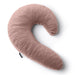 The Liberator Lune Snuggle Pillow with Vibrator Pocket is a soft, pink, crescent-shaped side sleeper pillow with a plush fabric cover and a small black tag on the seam, shown on a white background.