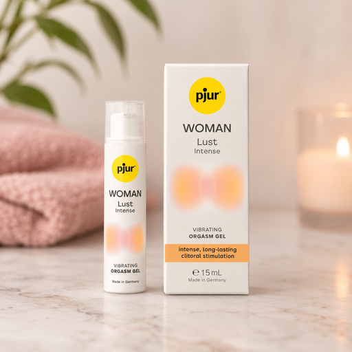 Pjur Lust Intense clitoral stimulation gel bottle and white box on a marble surface with a pink towel and candle.