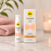 Pjur Lust Intense clitoral stimulation gel bottle and white box on a marble surface with a pink towel and candle.