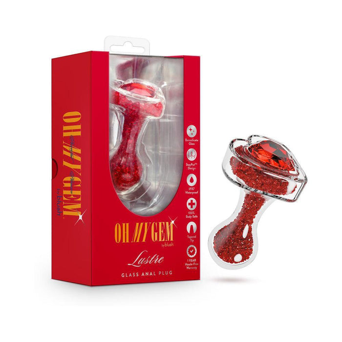 The Lustre Glass Butt Plug with Gem Base & Red Crystals, shown next to its bold "OH MY GEM Lustre" packaging, features a heart-shaped base and displays its borosilicate glass design on the box.