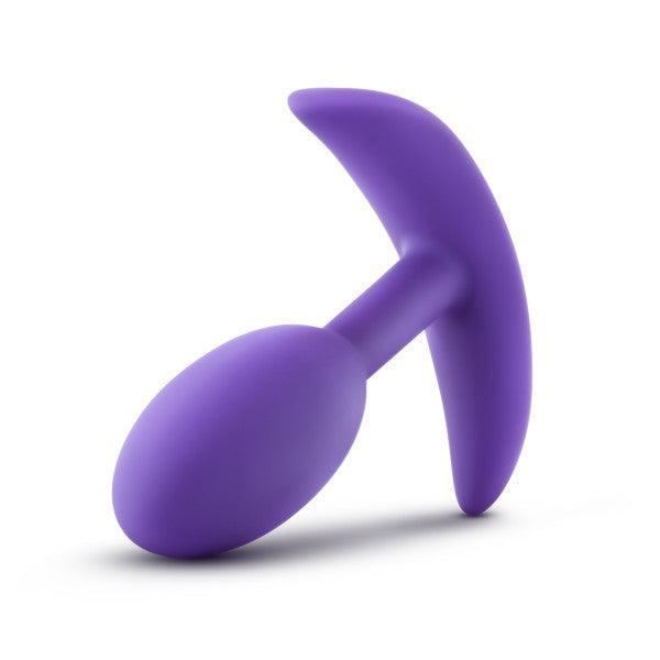 The Luxe Small Wearable Silicone Vibra Slim Plug in Purple by Blush is a smooth, hypoallergenic anal toy designed for sexual pleasure. It features a sleek, matte finish and includes a rounded, tapered tip with a T-shaped base.