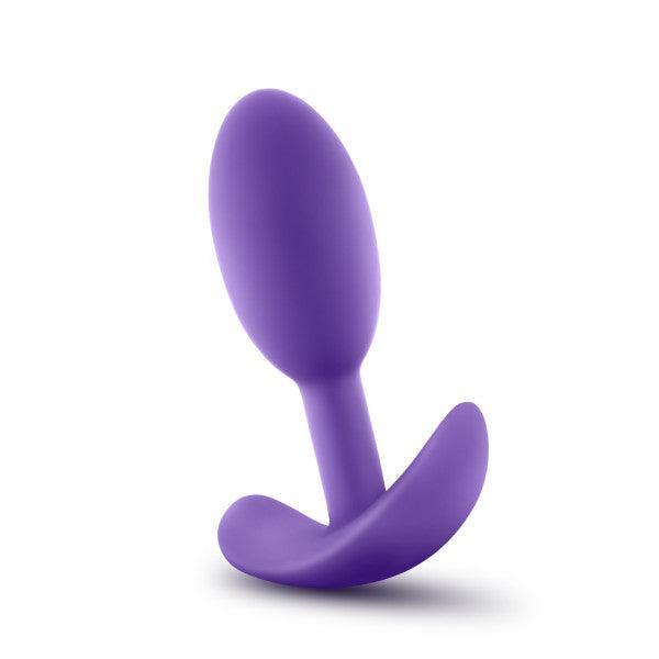 The Blush Luxe Small Wearable Silicone Vibra Slim Plug in purple features a smooth, tapered design and a curved base for safe and comfortable use. This hypoallergenic anal toy stands upright, showcasing its sleek, ergonomic shape against a plain white background.
