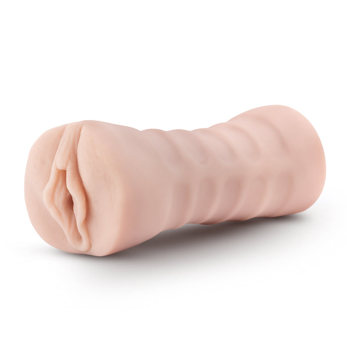 Experience ultimate pleasure with the M For Men Ashley Vibrating Pocket Pussy by Blush. This lifelike silicone masturbator is designed with a vaginal opening and comes in a flesh color. Its ribbed cylindrical shape features textured ridges for enhanced grip and can accommodate a vibrating bullet for added sensations.