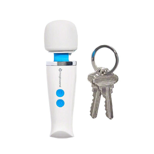 The Magic Wand Micro Rechargeable Cordless Vibrator by Vibratex, featuring a compact white design with a blue power button and a smaller blue button, sits upright with its head facing up next to a keychain holding two silver keys. The keys are attached to a metal ring beside the massager.