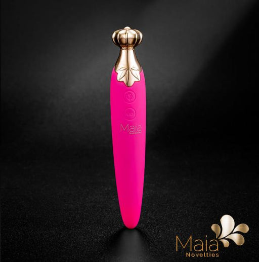 The Maia Vaporator Vape and Vibrator Combo - Pink is a sleek, rounded device with a silicone coating, featuring a golden crown-like tip and two control buttons. The words "Maia Toys" are printed on the vibrator, with the brand's logo displayed in the bottom right corner against a black background.