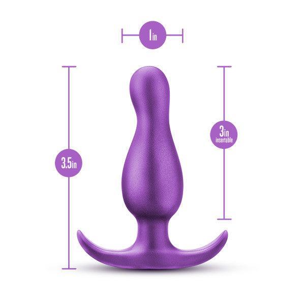 The Matrix First Time Flexible Silicone Butt Plug - Galactic Purple by Blush is showcased with a width of 1 inch and a total height of 3.5 inches. The insertable length measures 3 inches, crafted from body-safe silicone. The plug features a flared and curved base, providing safe removal and P spot stimulation.